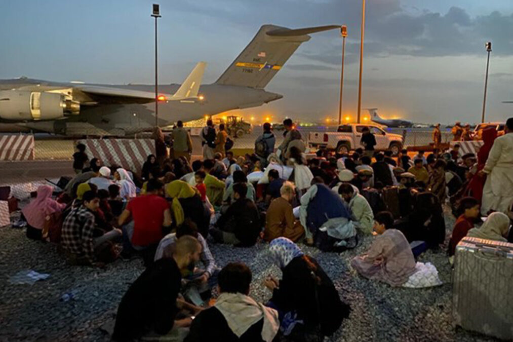 Afghan families waiting for their turn to be flown out of the country from Kabul airport on August 16, 2021.