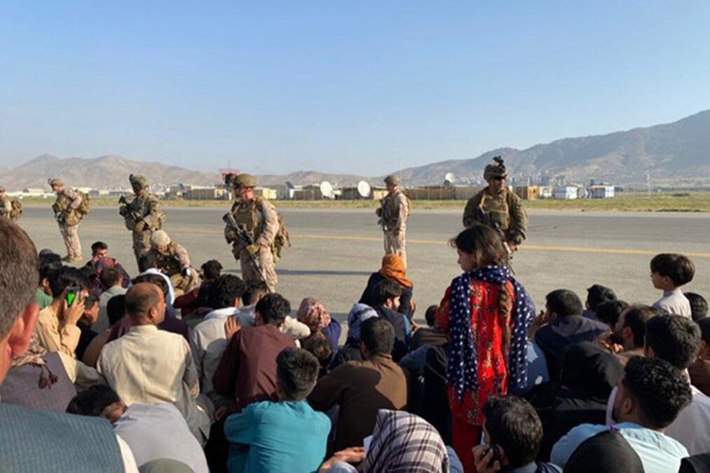Afghan families waiting at Kabul airport while US forces having a watch on them on August 16, 2021, a day after fall of Kabul to the Taliban.