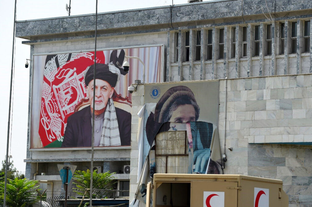 Portraits of former president Ashraf Ghani and national hero Ahmad Shah Massoud at Kabul Airport after it was taken over by Taliban on August 31, 2021.