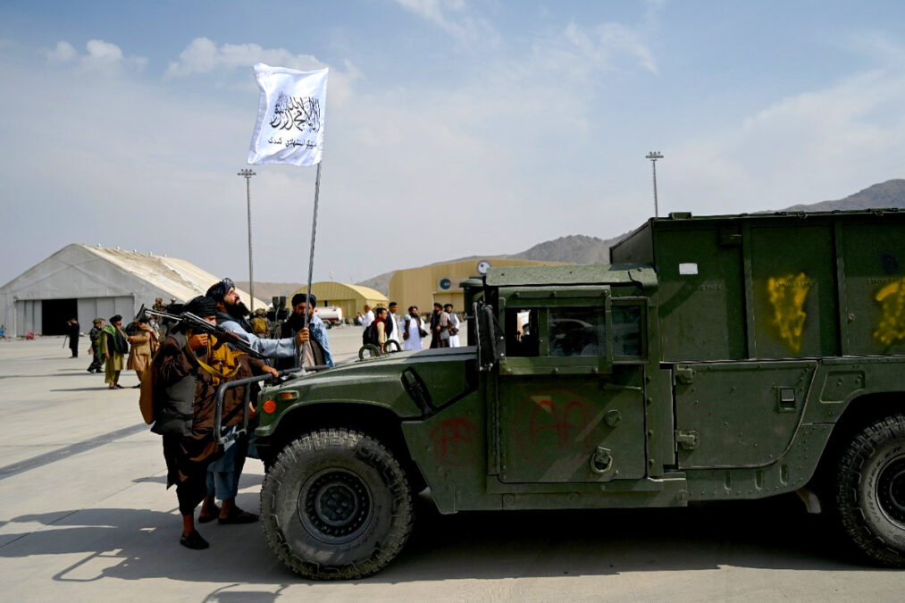 Taliban fighters near a military vehicle at Kabul Airport on August 31, a day after full withdrawal of US and coalition forces from the airport.